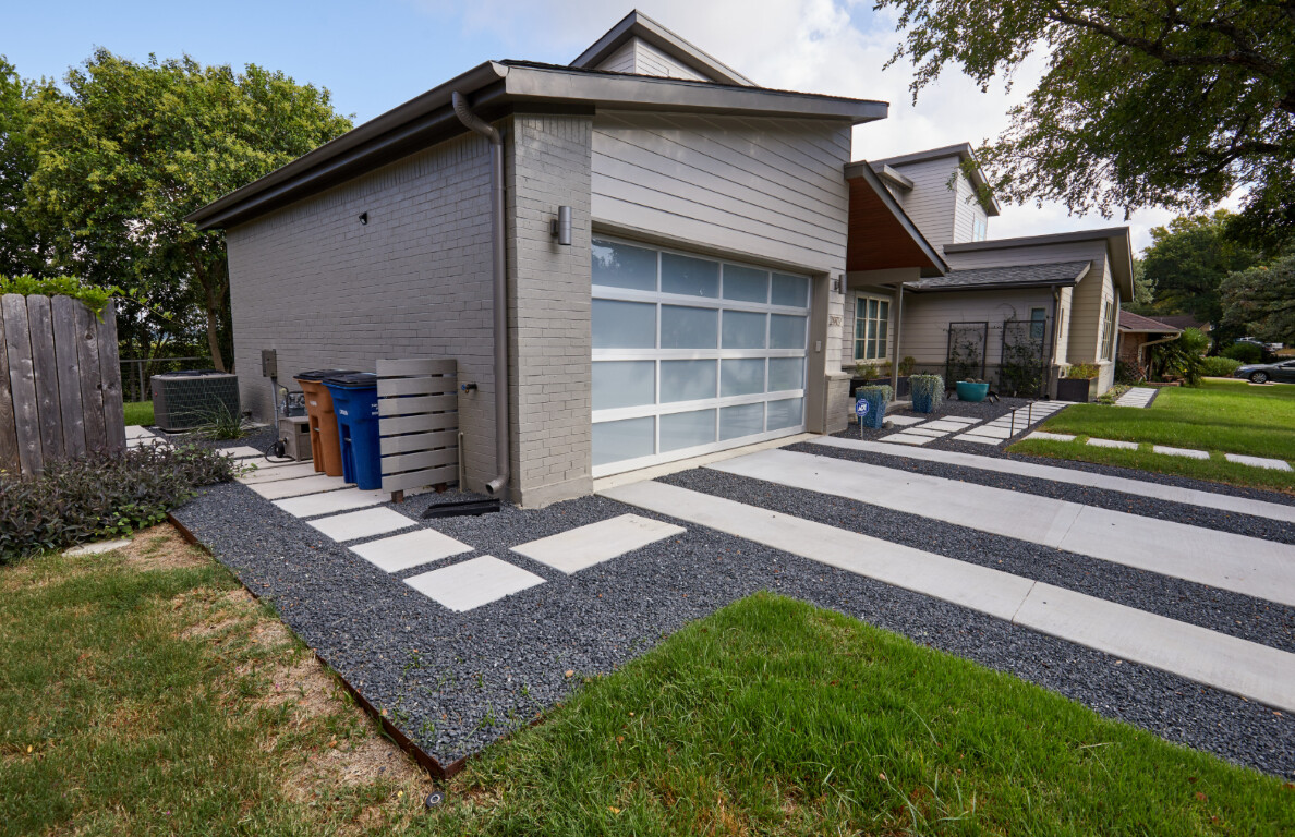 Modern concrete driveway with decorative gravel strips